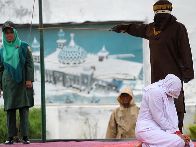 A Muslim woman cries out as she gets caned for being caught in proximity with a male in Banda Aceh on October 17, 2016. Indonesia's Aceh province has gained international infamy for its strict Islamic laws. Picture: AFP