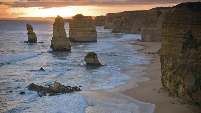 The Twelve Apostles at sunset. Soon, hundreds of little penguins will make their way ashore here, giving visitors on the lookout above the beach a commanding view of the penguin parade. Picture: Parks Victoria