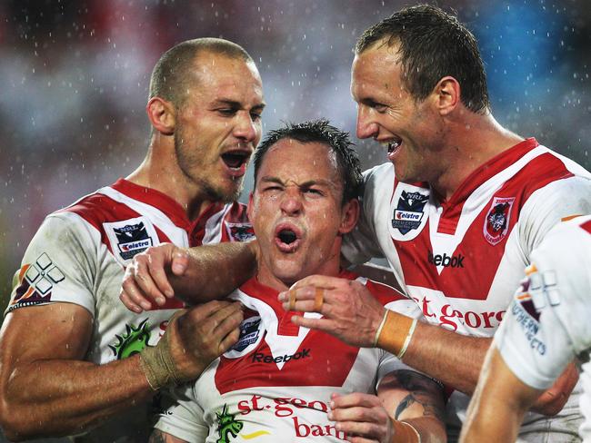 Kick start the party: Nathan Fien after scoring the final try, enjoys the moment with Matt Cooper (left) and Mark Gasnier.