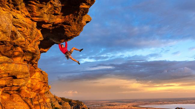 Free climber Tom Perkins tackles the grade 21 Feeling the Ceiling near the summit of Mount Arapiles in Victoria. Picture: Jason Edwards