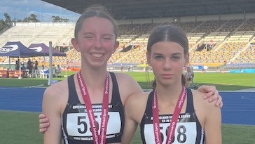 Zara Moore and Maeve McCowan of Brisbane State High after the Steeple Chase.