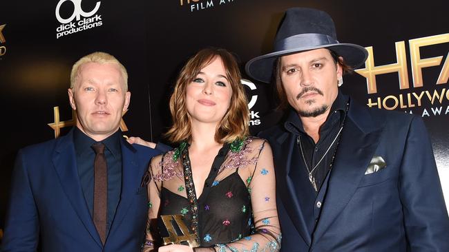 Actors Joel Edgerton, Dakota Johnson and Johnny Depp at the awards at The Beverly Hilton Hotel.