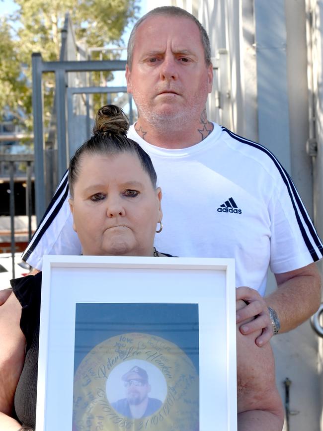 Tracey Dargan holds a photo of her son Peter Hooker.