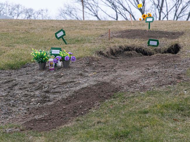 Flowers are placed on fresh graves at Woodlawn Cemetery in New York. The US death toll from Covid-19 has passed 700,000. Picture: AFP