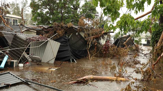 A storm over the Gold Coast has dropped rain causing flooding in Coomera. This house on Rivendell Drive has been hammered by the fallen trees from the Christmas Day storm only to be flooded by the Coomera River after this rain event. Pics Adam Head