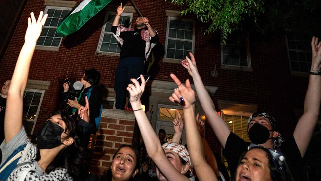 Pro-Palestinian demonstrators dance in the street near the George Washington University administrative offices.