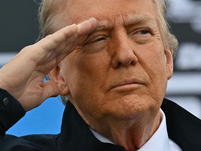 TOPSHOT - US President Donald Trump salutes during a flyover as he attends the Daytona 500 NASCAR race at Daytona International Speedway in Daytona Beach, Florida, on February 16, 2025. (Photo by ROBERTO SCHMIDT / AFP)