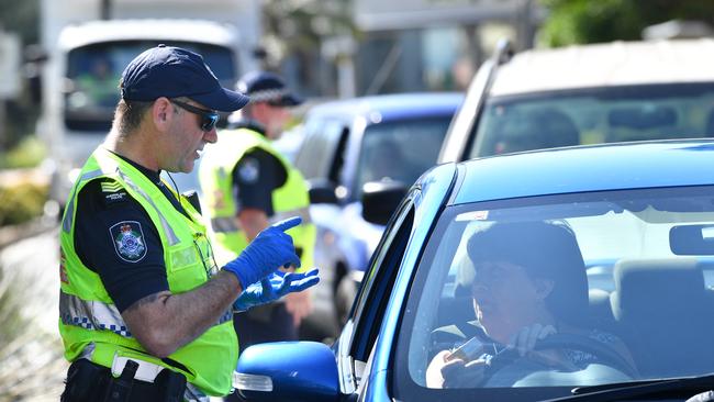 Police at a check point on the Queensland and New South Wales border on Griffith Street in Coolangatta. Picture: AAP.