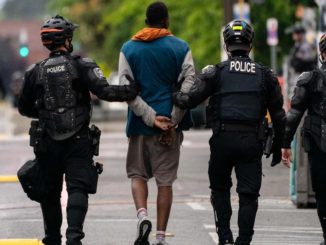 Police detain a person as city crews dismantle the Capitol Hill Organized Protest (CHOP) area. Picture: AFP