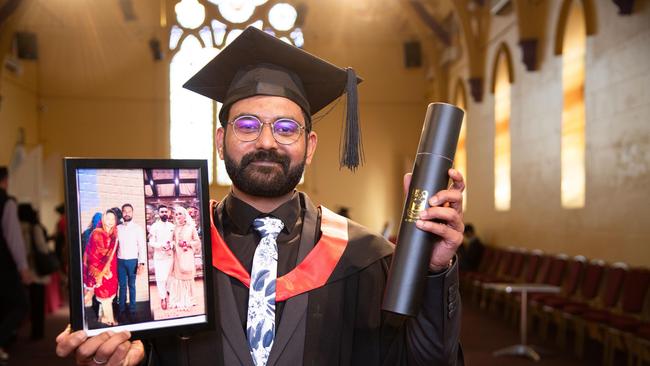 Holding a photograph of his wife, Bashir, who was unable to attend the graduation, Muhammad Farooq Bashir, graduated with a Master of Information Systems. UniSQ graduation ceremony at Empire Theatre. Wednesday, June 28, 2023