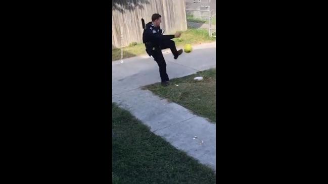 QLD police officer kicks a ball with kids while on patrol