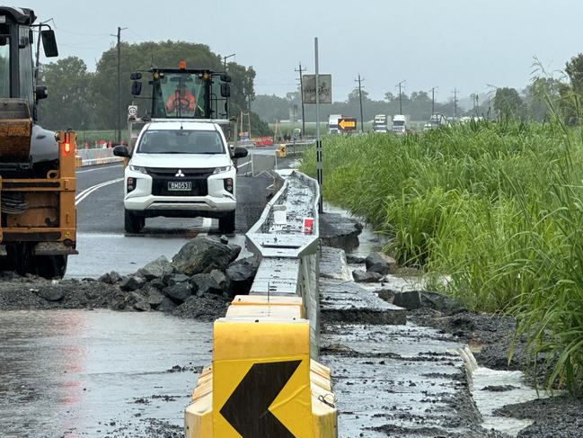 Crews work to make emergency repairs along the Bruce Highway at Calen after heavy rain reduced it to rubble. January 14, 2023. Picture: Heidi Petith