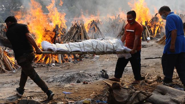 People carry the body of a person who died from coronavirus during a mass cremation, at a crematorium in New Delhi. Picture: Getty Images