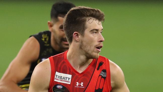 PERTH, AUSTRALIA - JUNE 05: Zach Merrett of the Bombers looks to pass the ball during the 2021 AFL Round 12 match between the Essendon Bombers and the Richmond Tigers at Optus Stadium on June 5, 2021 in Perth, Australia. (Photo by Will Russell/AFL Photos via Getty Images)