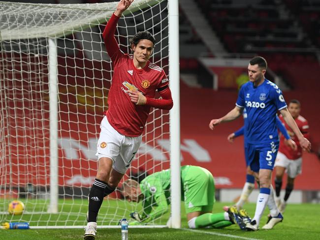 Manchester United's Uruguayan striker Edinson Cavani celebrates scoring his team's first goal during the English Premier League football match between Manchester United and Everton at Old Trafford in Manchester, north west England, on February 6, 2021. (Photo by Michael Regan / POOL / AFP) / RESTRICTED TO EDITORIAL USE. No use with unauthorized audio, video, data, fixture lists, club/league logos or 'live' services. Online in-match use limited to 120 images. An additional 40 images may be used in extra time. No video emulation. Social media in-match use limited to 120 images. An additional 40 images may be used in extra time. No use in betting publications, games or single club/league/player publications. /