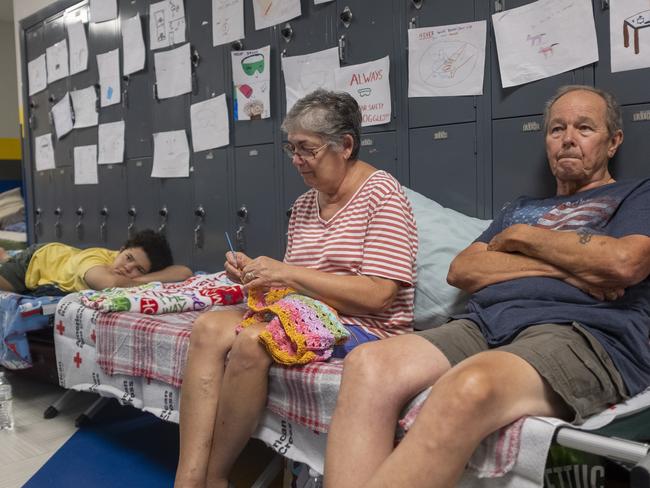 Gordon and Dina Reynolds, with their 11-year-old granddaughter, Abby, sit on cots in the hall way of the North Myrtle Beach High School that is currently being used as a Red Cross evacuation shelter in North Myrtle Beach, South Carolina. Picture: Jason Lee/The Sun News via AP