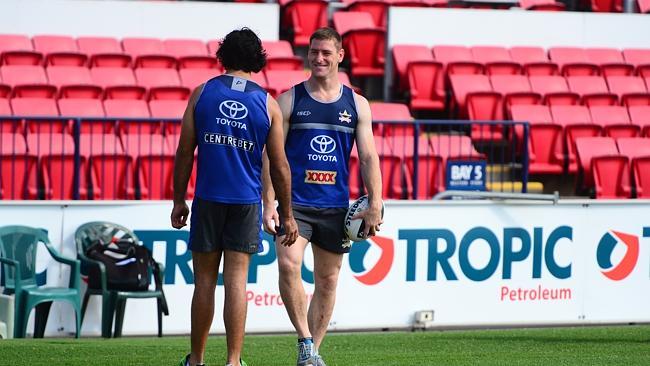 Brent Tate and Johnathan Thurston fool around on the sideline during training. 