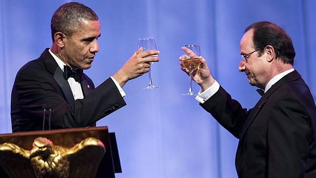 Exquisite taste: US President Barack Obama and French President Francois Hollande toast each other during a State Dinner at the White House on February 11, 2014. Picture: AFP