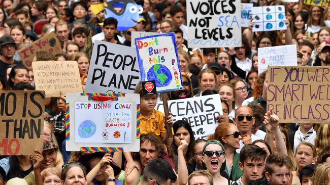 Schoolchildren shout slogans during a strike and protest against inaction on climate change. Photo by Saeed Khan / AFP