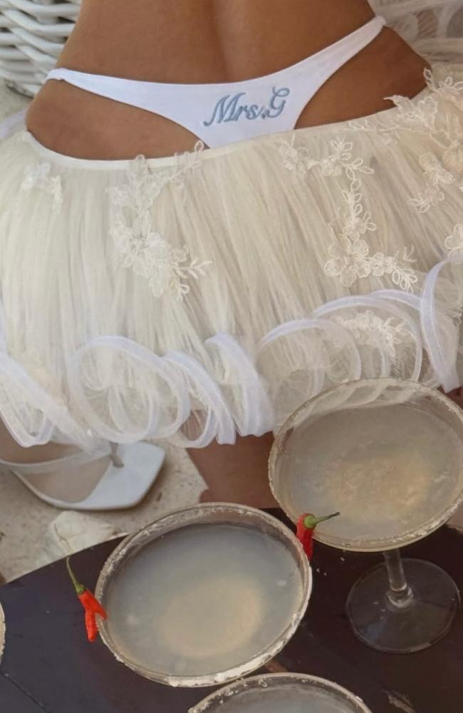 Her tiny outfit was completed with a visible G-string adorned with “Mrs G”. Picture: Instagram/Em Davies