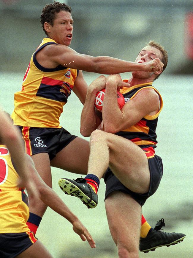 Michael Handby, pictured left in 2001, was teammates with Laurence Angwin at Dandenong Stingrays, Glenelg and with the Crows.