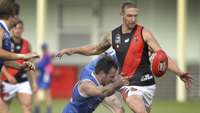 Adelaide Footy League division one game between St Peter's Old Collegians and Tea Tree Gully at St Peters. TT Gully's Jack Astbury tries to clear under pressure from St Peters Sam Stott. 11 May 2019. (AAP Image/Dean Martin)