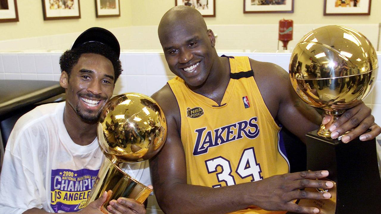 Los Angeles Lakers stars Kobe Bryant and Shaquille O'Neal holds Larry O'Brien trophy in 2000.