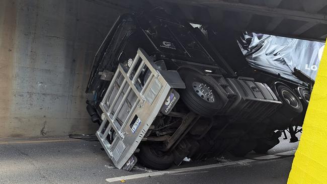 A B-double semi trailer has become wedged under a Corinda rail bridge. Picture: Facebook/Daniel Harper