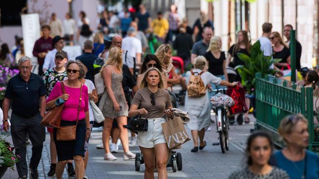 Swedes don’t bother with social distancing or masks as they walk in Stockholm. Picture: AFP.