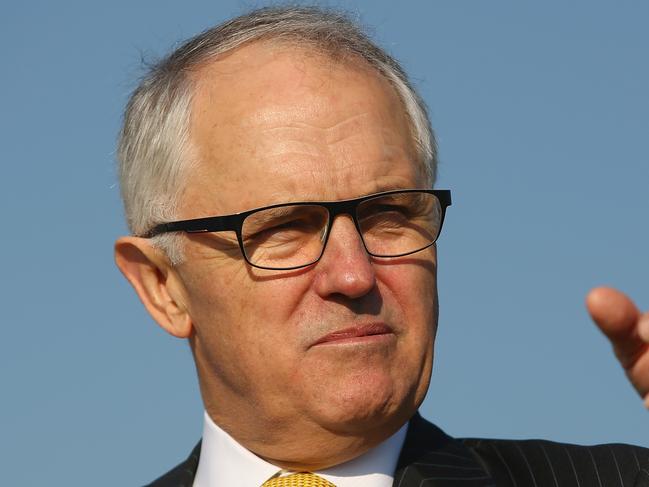 SYDNEY, AUSTRALIA - AUGUST 21: Australian politician Malcolm Turnbull discusses the musicians forming a human wall on a cliff near Macquarie Lighthouse representing standing in the way of suicide to raise awareness for the upcoming Concert For Life on August 21, 2015 in Sydney, Australia. Members of the Sydney Symphony Orchestra lined the cliff to raise awareness of suicide prevention. (Photo by Mark Kolbe/Getty Images)