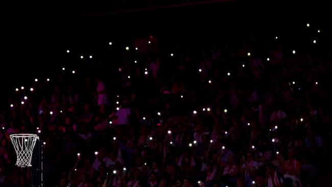 ADELAIDE, AUSTRALIA – MARCH 25: Fans hold torches as a power cut affects parts of the stadium during the round two Super Netball match between Adelaide Thunderbirds and NSW Swifts at Netball SA Stadium on March 25, 2023 in Adelaide, Australia. (Photo by Graham Denholm/Getty Images)