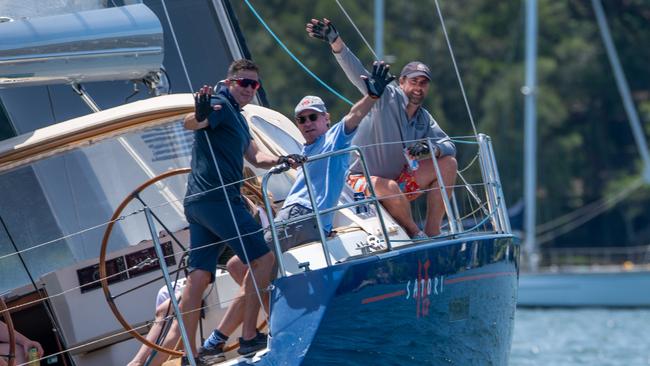 Crew members of Satori wave to the camera. Picture: Thomas Lisson