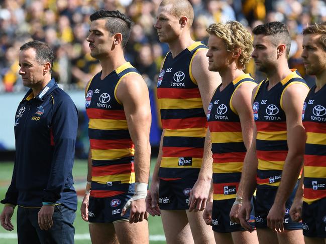 Crows coach Don Pyke (left) is seen during the national anthem before the AFL grand final between the Adelaide Crows and Richmond Tigers at the MCG in Melbourne, Saturday, September 30, 2017. (AAP Image/Julian Smith) NO ARCHIVING, EDITORIAL USE ONLY