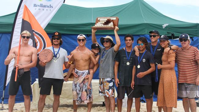 The Snapper Rocks Surfiders Club celebrating their 24th Straddie Teams Assault at North Stradbroke Island (from left) Jaggar Bartholomew, Jay Phillips, Dextar Muskens, (Soraya Phillips on Dex’s shoulders), Mitch Parkinson, Thomas Carvalho, Jay Occhilupo, Kai Tandler, Kobie Enright and Rabbit Bartholomew. Photo: Fiona Pyke/Straddie Surf Pics.