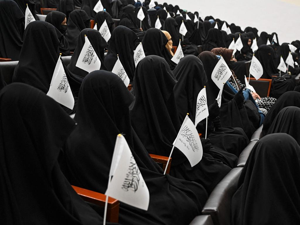 Veiled students hold Taliban flags at the University of Kabul. Picture: Aamir Qureshi/AFP