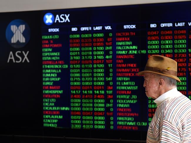 A man looks at stock prices displayed on an information screen at the Australian Securities Exchange (ASX) in Sydney, Monday, Sept. 12, 2016. The benchmark S&P/ASX 200 index was down 1.8 per cent at 1017 AEST, with all 12 indexes trading in red following a big sell-off on Wall Street. (AAP Image/Paul Miller) NO ARCHIVING