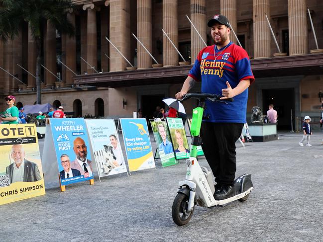 NRL Magic Round fan rides past the Brisbane City Hall polling station. Picture: NewsWire/Tertius Pickard