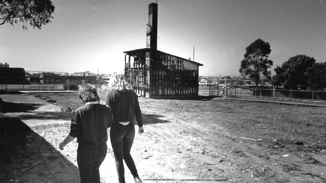 Students walk past the remains of the business studies area destroyed by fire at Preston Technical School in 1987.