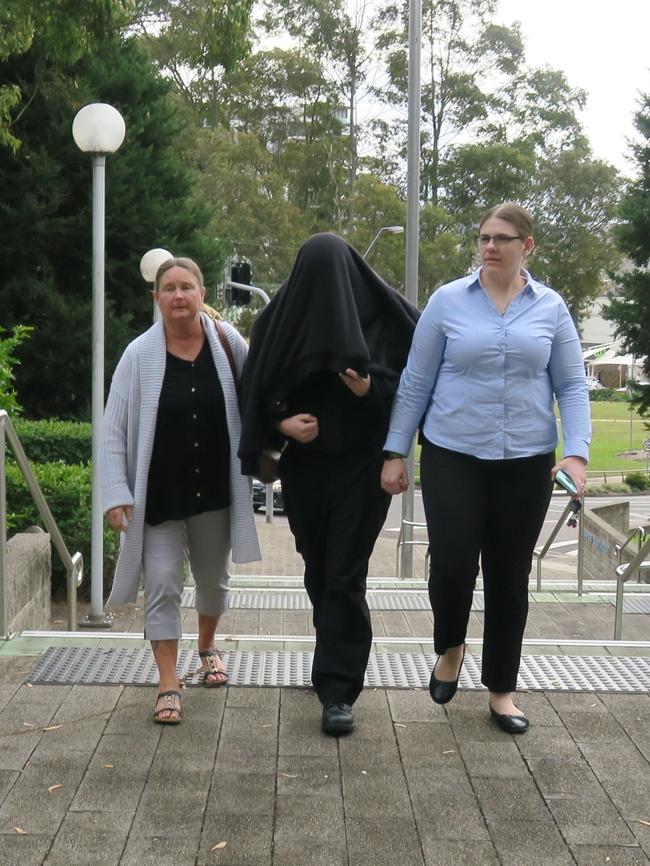 Hiding as he comes into court.