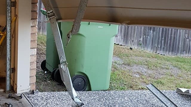 Damaged caused to Brassall mum Cathy Goodwin’s garage after the man allegedly crashed her car through the door and into the families other car. Picture: Contributed