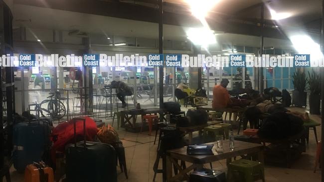 Stranded travellers sleep outside Gold Coast Airport. Photo: Jay Gadhavi