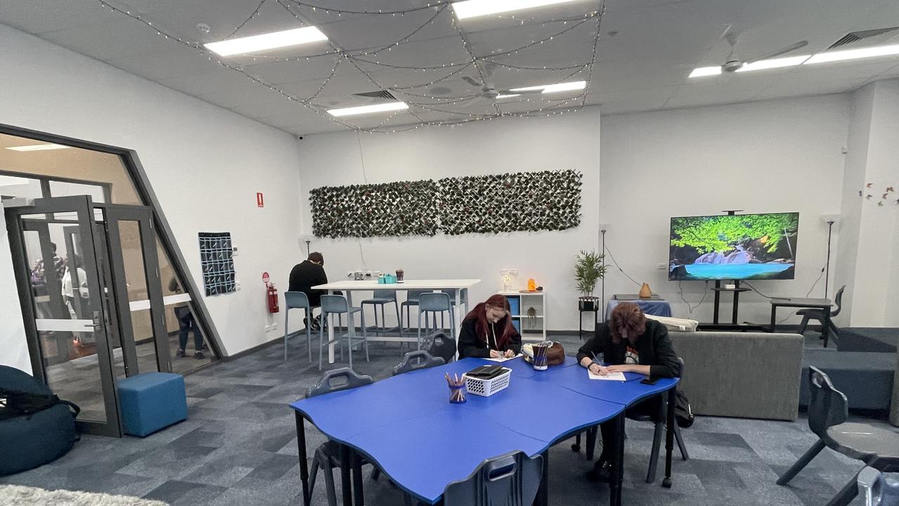 Classrooms have subdued lighting with couches and tables oriented towards group work.