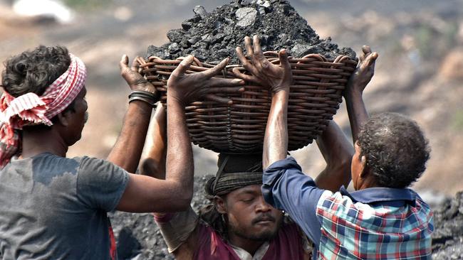 Workers prepare to load coal onto a truck at the Jharia coalfield in Dhanbad in India's Jharkhand state. Picture: AFP