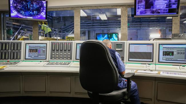 Screens and controls dominate the control room.