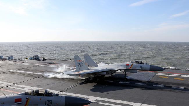 A Chinese J-15 fighter jet lands on the deck of the Liaoning aircraft carrier during military drills in the Bohai Sea, off China's northeast coast. Picture: AFP