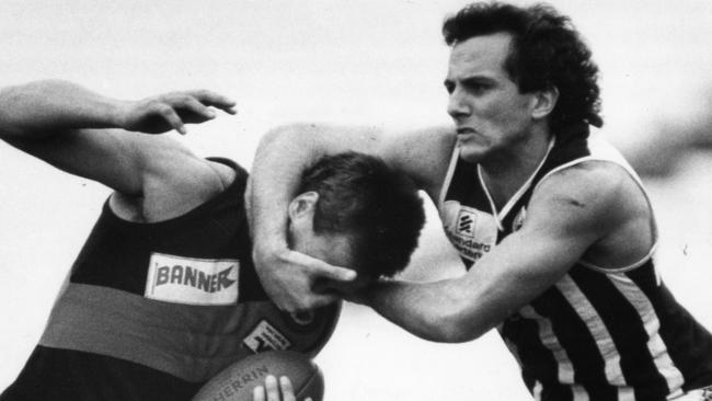 Former Port Adelaide player George Fiacchi applying a headlock to West Adelaide’s Carl Herbert during a Magpies v Bloods SANFL clash in 1987. Picture: News Corp, Graham Tidy