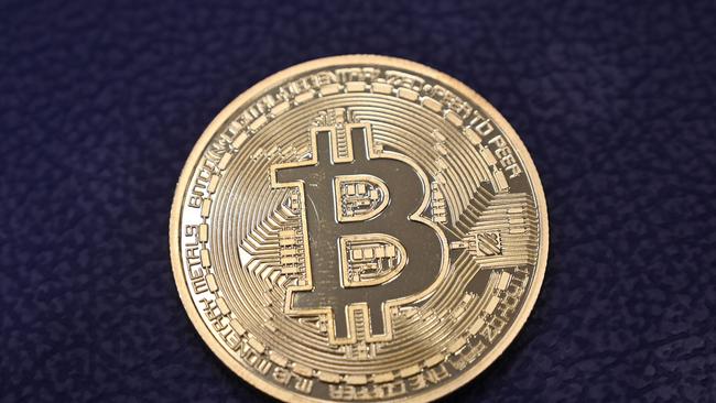 A physical imitation of a Bitcoin, which only exists in cyberspace. Picture: Ozan Kose/AFP