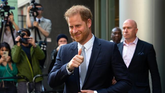 Prince Harry gives a thumbs up as he leaves after court giving evidence at the Mirror Group phone hacking trial. Picture: Getty Images.