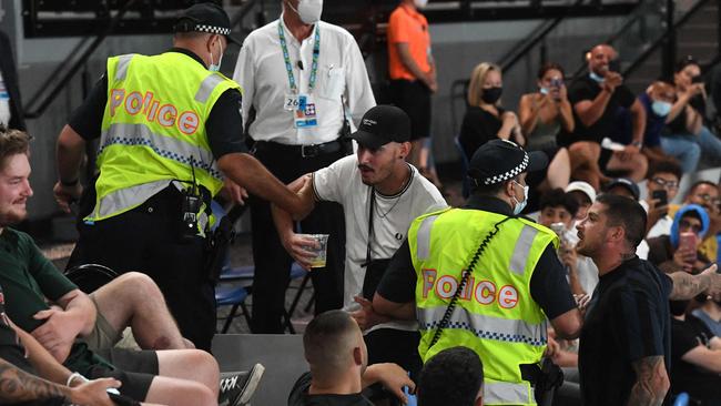 Police escort rowdy fans from the arena as Italy's Matteo Berrettini beats France's Gael Monfils