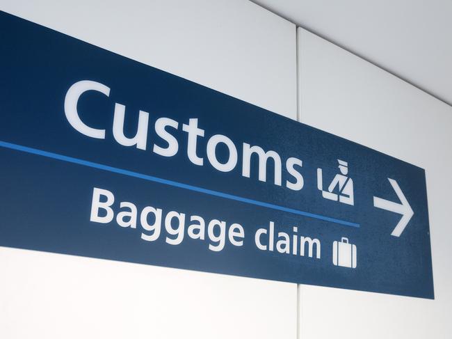 "Customs" and "Baggage Claim" direction sign at Sydney International Airport.